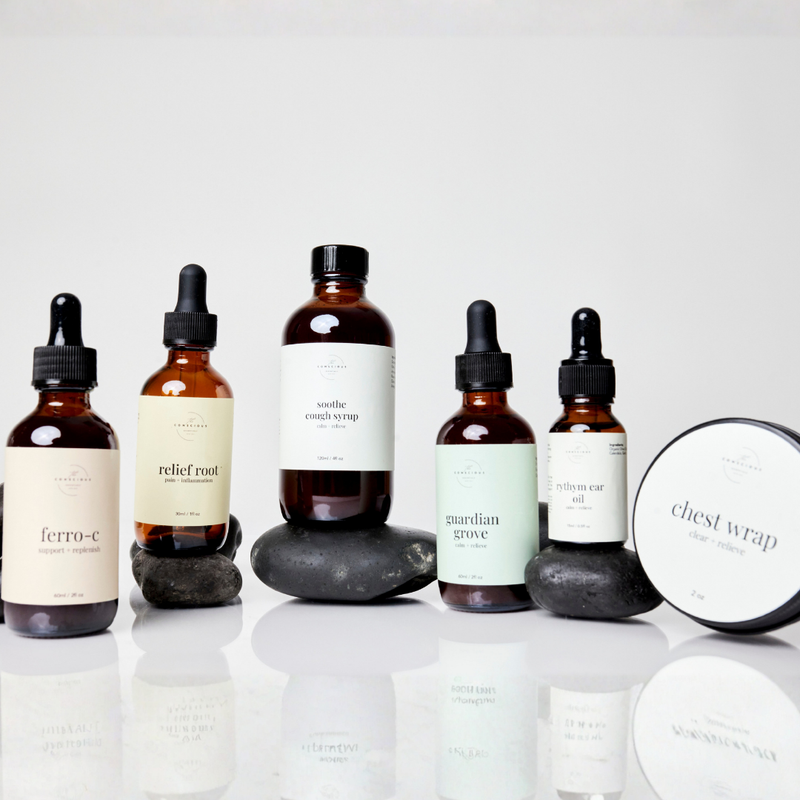 Collection of natural remedy bottles and a chest wrap on a white background. Products from the Conscious Essentials